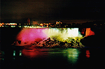 The American Falls illiminated by a rainbow of lights
