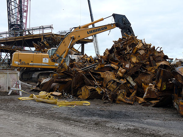 A hydraulic scrap cutter making easy prey of the Invert Carrier - cutter uses 3000 tons pressure to cut steel 